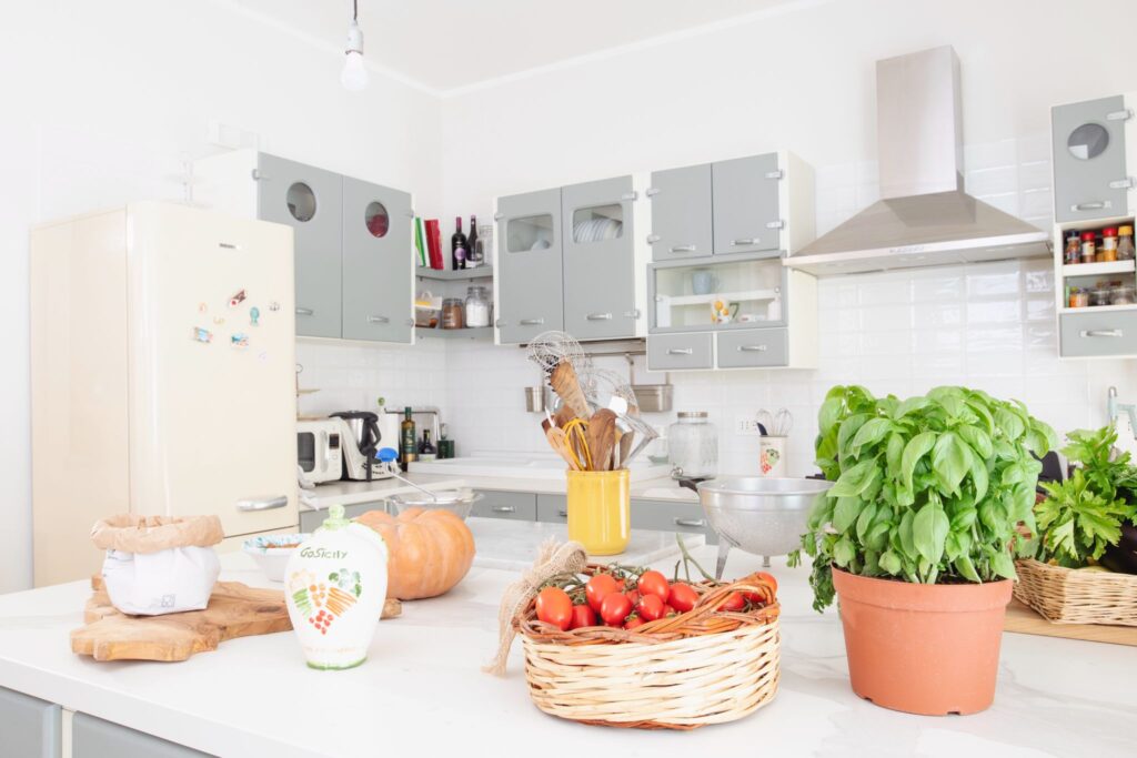 Basil and tomatoes sit atop a kitchen counter in sicily