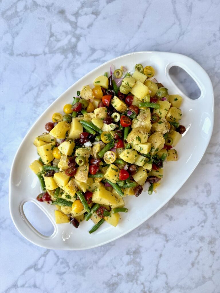 Italian Potato Salad recipe from You Got This! with potato, green beans, tomatoes and olives