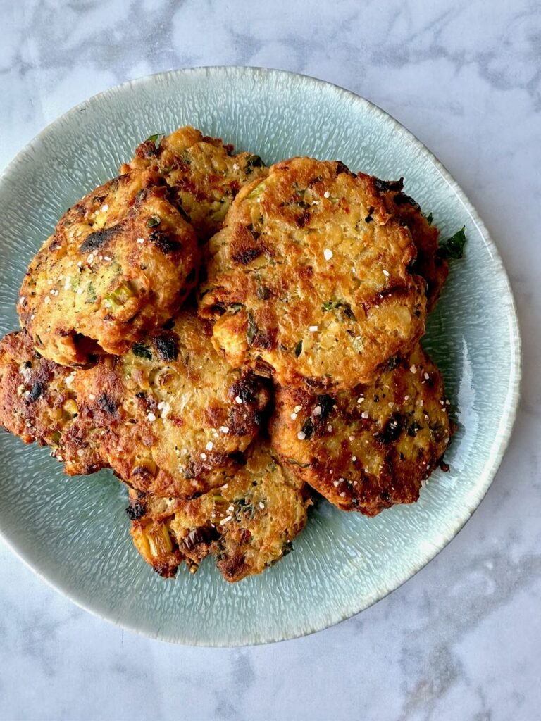 Chickpea fritters stacked on a blue agate plate